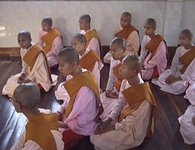 group of nuns sitting, respectfully earing a teaching