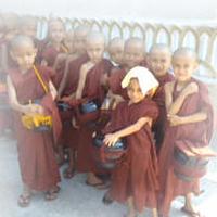 group of young novices, standing with their bowls
